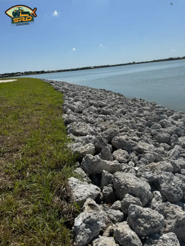 SRQ Grading installing riprap on a waterfront property in Bradenton Florida to prevent erosion and stabilize the shoreline