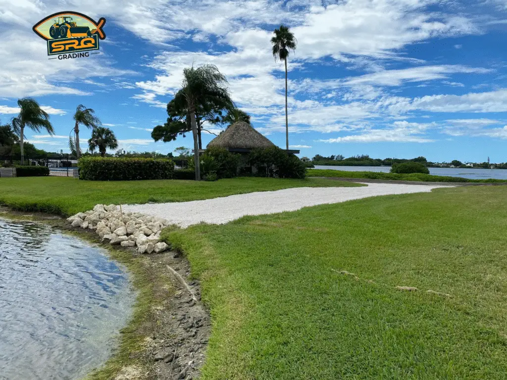 Land clearing equipment removing trees, brush, and debris on a residential lot in Sarasota, Florida
